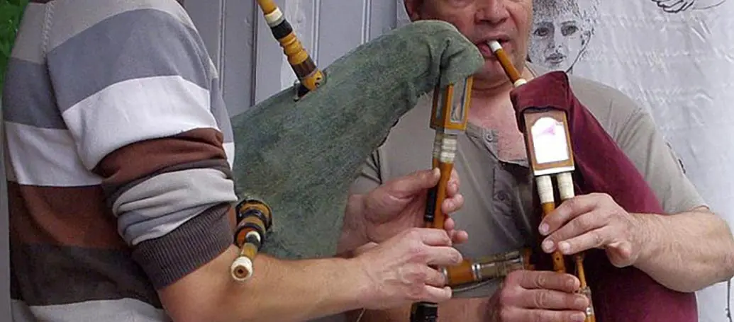 Bagpipe instructor teaching a student